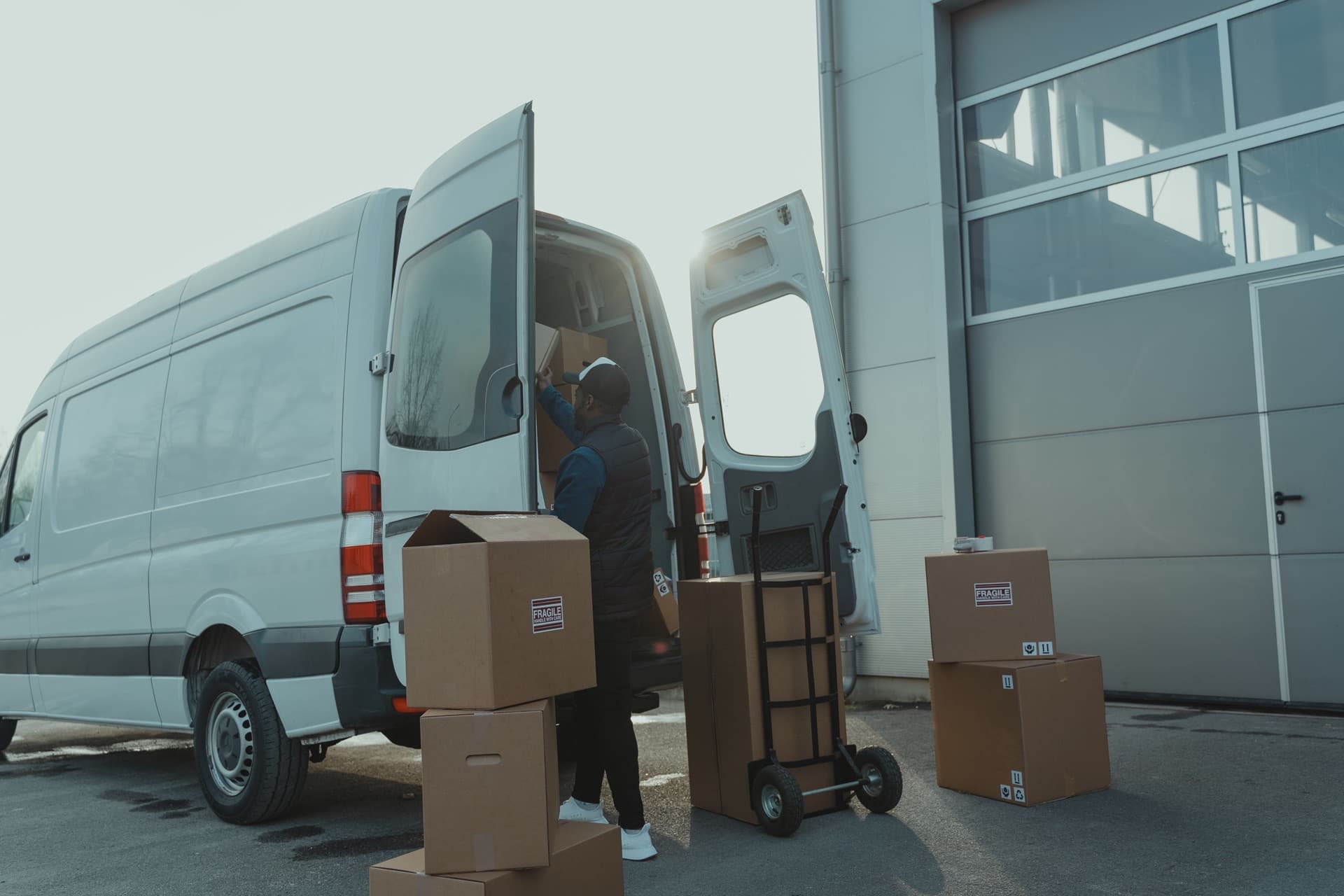 Boxes and a hand truck being loaded into a moving van